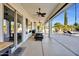 Long covered patio with seating, ceiling fans and a view of the pool at 21151 E Mewes Rd, Queen Creek, AZ 85142