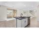 Open kitchen with island, stainless steel appliances, and view into living room at 9239 E Spiral Ave, Mesa, AZ 85212