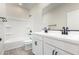 Bathroom with white cabinets, double vanity, and bathtub at 9239 E Spiral Ave, Mesa, AZ 85212