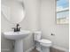 Modern bathroom with pedestal sink, toilet, and large mirror at 9239 E Spiral Ave, Mesa, AZ 85212