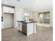 Open kitchen with island, stainless steel appliances, and view into living room at 9239 E Spiral Ave, Mesa, AZ 85212