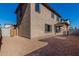 Two-story house with a tan exterior, wood gate, and a small backyard at 9239 E Spiral Ave, Mesa, AZ 85212