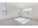 Spacious bedroom featuring a large window and carpeted floor at 9239 E Spiral Ave, Mesa, AZ 85212