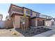 Two-story house with brown and tan exterior, two-car garage, and landscaping at 9239 E Spiral Ave, Mesa, AZ 85212