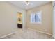 Bright bedroom with plush carpet, ceiling fan, and access to bathroom at 26562 W Vista North Dr, Buckeye, AZ 85396