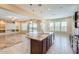 Open kitchen features granite island, hardwood floors, and views to backyard at 26562 W Vista North Dr, Buckeye, AZ 85396