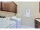 Convenient laundry room with washer, dryer, and ample cabinetry at 26562 W Vista North Dr, Buckeye, AZ 85396