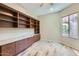 Home office with built-in shelving and hardwood floors at 26562 W Vista North Dr, Buckeye, AZ 85396