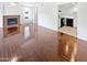 Bright living room with dark hardwood floors, fireplace and kitchen views at 2040 S Longmore -- # 80, Mesa, AZ 85202