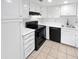 Clean kitchen featuring white cabinetry, black appliances, and tile flooring at 2040 S Longmore -- # 80, Mesa, AZ 85202