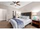 Main bedroom with ceiling fan and ensuite bathroom access at 2511 W Queen Creek Rd # 425, Chandler, AZ 85248