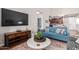 Living room with blue sofa and large flat-screen TV at 2511 W Queen Creek Rd # 425, Chandler, AZ 85248