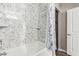 Bathroom with marble-look walls and a shower/tub combo at 2511 W Queen Creek Rd # 425, Chandler, AZ 85248