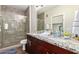 Double vanity bathroom with granite countertop and a walk-in shower at 2511 W Queen Creek Rd # 425, Chandler, AZ 85248