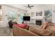Gathering room with fireplace, comfortable seating, and large TV at 1201 W Washington Ave, Gilbert, AZ 85233