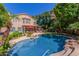 Inviting pool with rock waterfall feature and lush landscaping at 1201 W Washington Ave, Gilbert, AZ 85233