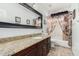 Bathroom with granite vanity, tub shower combo and decorative curtains at 1201 W Washington Ave, Gilbert, AZ 85233