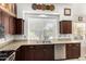 Kitchen boasts granite countertops and a large window overlooking the backyard at 1201 W Washington Ave, Gilbert, AZ 85233