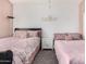 Well-lit bedroom featuring two beds and soft color scheme at 1201 W Washington Ave, Gilbert, AZ 85233