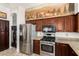 Kitchen with stainless steel appliances and dark wood cabinetry at 1201 W Washington Ave, Gilbert, AZ 85233