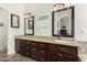 Double vanity bathroom with granite countertops and dark wood cabinets at 1201 W Washington Ave, Gilbert, AZ 85233