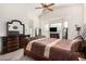 Main bedroom with large bed, dresser, and TV at 1201 W Washington Ave, Gilbert, AZ 85233