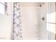 Clean bathroom with a shower/tub combo and patterned shower curtain at 2650 W Union Hills Dr # 114, Phoenix, AZ 85027
