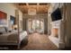 Spacious main bedroom with fireplace, hardwood floors, and French doors to a private balcony at 10947 E Wingspan Way, Scottsdale, AZ 85255