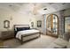 Spacious main bedroom with sitting area and French doors leading to patio at 10947 E Wingspan Way, Scottsdale, AZ 85255