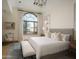 Spacious bedroom with large window, featuring a king-size bed and sitting area at 10947 E Wingspan Way, Scottsdale, AZ 85255