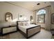 Bright bedroom with large arched window, offering scenic mountain views at 10947 E Wingspan Way, Scottsdale, AZ 85255