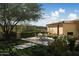 Elegant patio with seating area, lush landscaping, and mountain views at 10947 E Wingspan Way, Scottsdale, AZ 85255