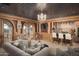 Spacious game room with wet bar, comfortable seating, and mountain views at 10947 E Wingspan Way, Scottsdale, AZ 85255