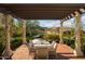 Outdoor dining area with brick patio, pergola, and mountain views at 10947 E Wingspan Way, Scottsdale, AZ 85255
