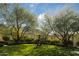 Serene garden with manicured lawn and modern sculpture at 10947 E Wingspan Way, Scottsdale, AZ 85255