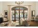 Elegant living room with pool view, featuring a comfortable sofa and large windows at 10947 E Wingspan Way, Scottsdale, AZ 85255