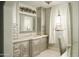 Elegant bathroom vanity with custom cabinetry, quartz countertops, and a large mirror at 10947 E Wingspan Way, Scottsdale, AZ 85255