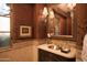 Powder room with ornate mirror and decorative wallpaper at 10947 E Wingspan Way, Scottsdale, AZ 85255