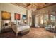 Luxurious main bedroom with hardwood floors, a large bed, and access to a private balcony at 10947 E Wingspan Way, Scottsdale, AZ 85255
