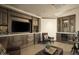 Home bar with a wine cooler, plenty of cabinet space, and a large TV at 10947 E Wingspan Way, Scottsdale, AZ 85255