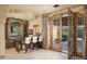 Elegant wet bar with granite counters, custom cabinetry, and French doors leading to the patio at 10947 E Wingspan Way, Scottsdale, AZ 85255