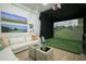 Recreational golf simulator room, featuring comfortable seating and large screen at 10947 E Wingspan Way, Scottsdale, AZ 85255