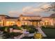 Elegant mansion with landscaped grounds at dusk at 10947 E Wingspan Way, Scottsdale, AZ 85255