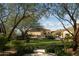 Landscaped backyard with lush greenery and a gazebo at 10947 E Wingspan Way, Scottsdale, AZ 85255