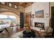 Spacious living area with a fireplace and access to a patio at 10947 E Wingspan Way, Scottsdale, AZ 85255
