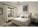 Serene bedroom with a cozy queen-size bed and ample natural light at 10947 E Wingspan Way, Scottsdale, AZ 85255