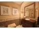 Elegant powder room features a decorative sink, vanity, and tiled floor at 10947 E Wingspan Way, Scottsdale, AZ 85255