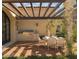 Brick patio with built-in grill, dining table, and pergola at 10947 E Wingspan Way, Scottsdale, AZ 85255