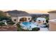 Stunning pool and spa area with mountain views and outdoor kitchen at 10947 E Wingspan Way, Scottsdale, AZ 85255