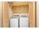 Convenient laundry room with washer, dryer, and built-in cabinetry at 8638 E Paraiso Dr, Scottsdale, AZ 85255